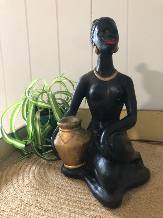 Lady with gold water jug. Black