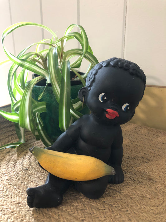 Baby with banana figurine. Black